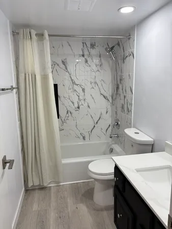 a bathroom with a toilet and a shower