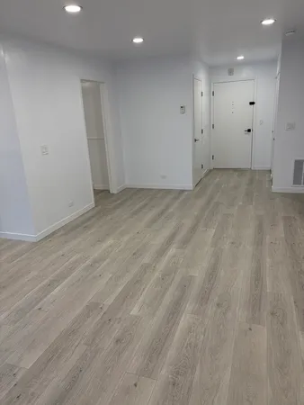 an empty room with wooden floor
