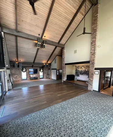 a living room with furniture a rug and a window