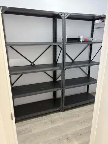 an empty room with wooden floor and sliding door