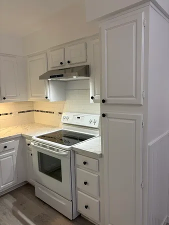 a kitchen with cabinets appliances and a sink
