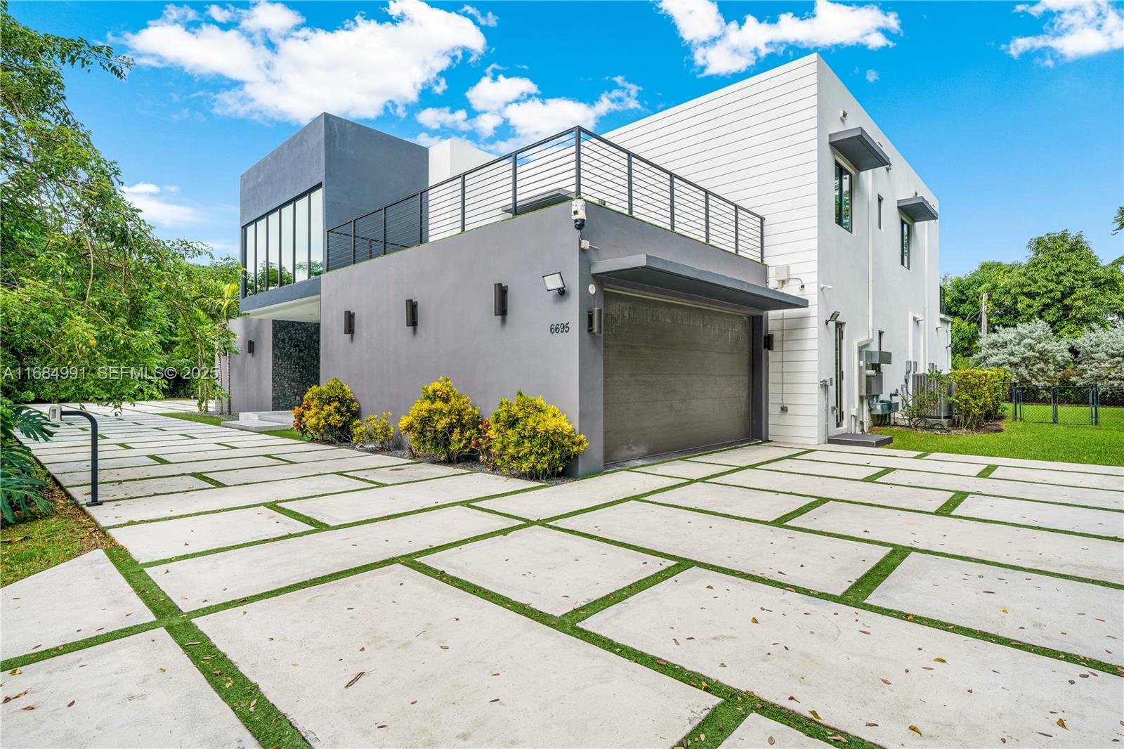 6695 Southwest 112th Street Pinecrest, FL 33156 - Photo 3 of 99 a view of a house with a street