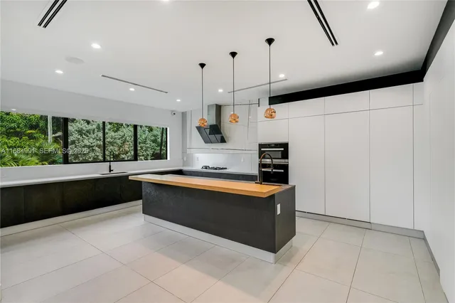a kitchen with a walk in closet and wooden floor