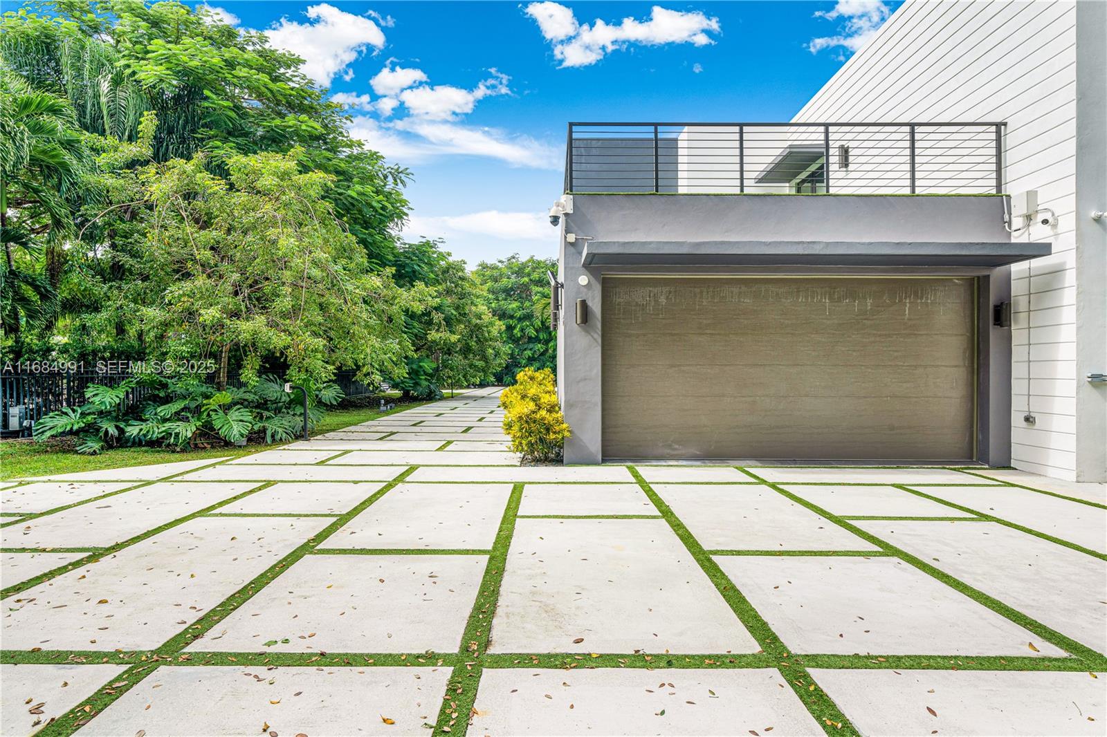 6695 Southwest 112th Street Pinecrest, FL 33156 - Photo 5 of 99 a stone house with a outdoor space