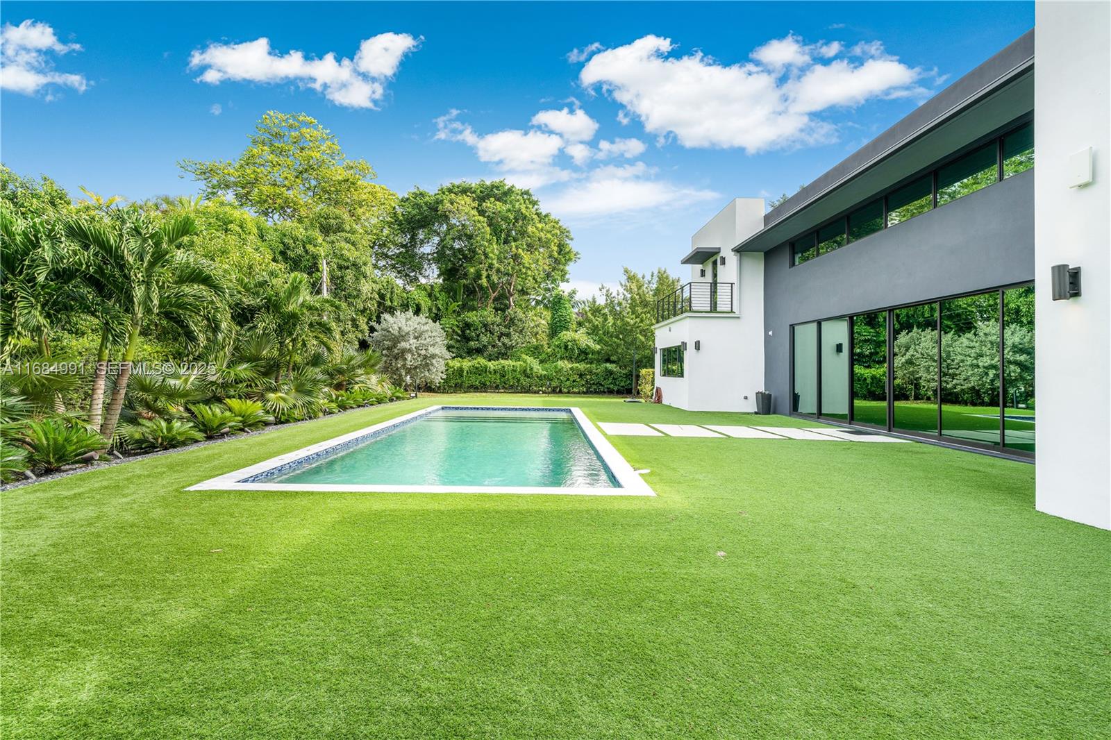 6695 Southwest 112th Street Pinecrest, FL 33156 - Photo 92 of 99 a view of a backyard with swimming pool
