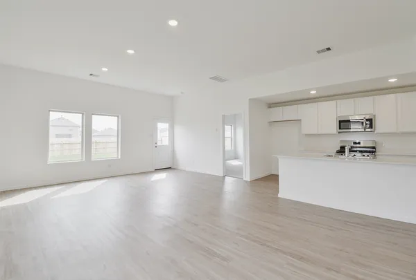 a view of kitchen with furniture and wooden floor