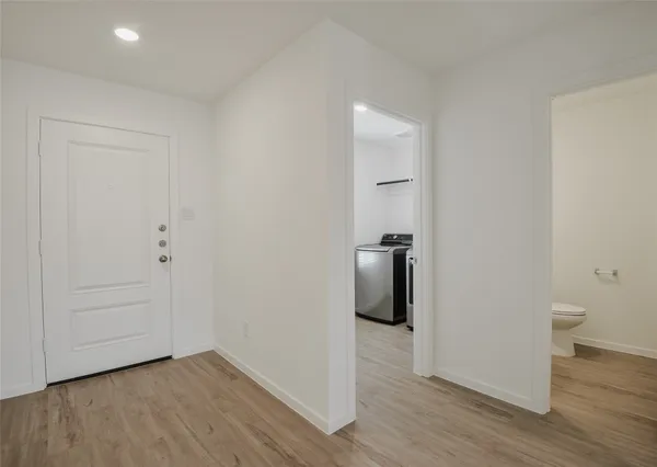 a view of a room with wooden floor and a toilet