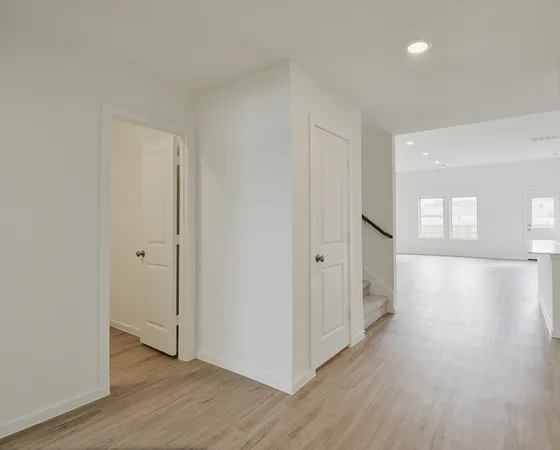 a view of a hallway with wooden floor