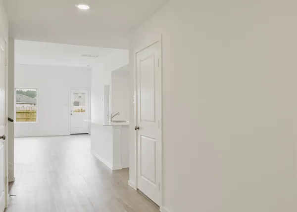a view of a hallway with wooden floor