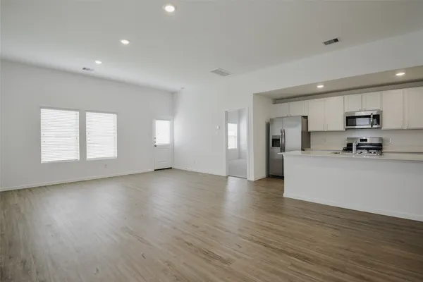 a view of kitchen with furniture and wooden floor