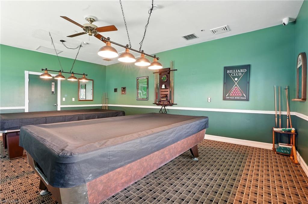 3113 Weathervane Drive Naples, FL 34120 - Photo 31 of 36 a bedroom with a bed and a dresser