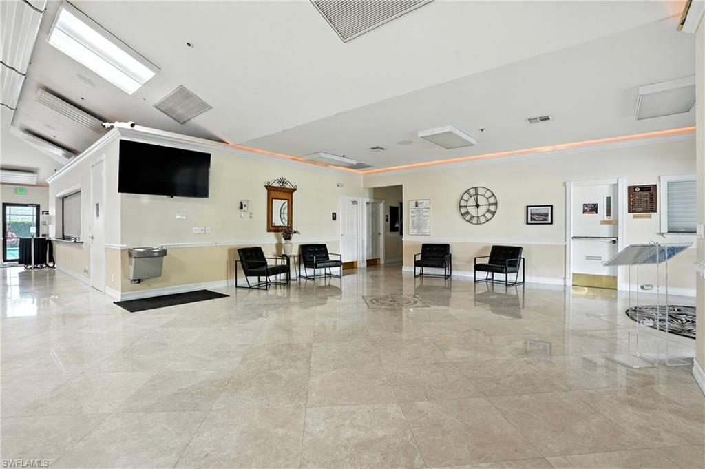 3113 Weathervane Drive Naples, FL 34120 - Photo 36 of 36 a living room with furniture and a flat screen tv