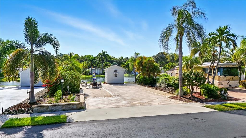 3113 Weathervane Drive Naples, FL 34120 - Photo 5 of 36 a palm tree sitting in front of a house with a yard