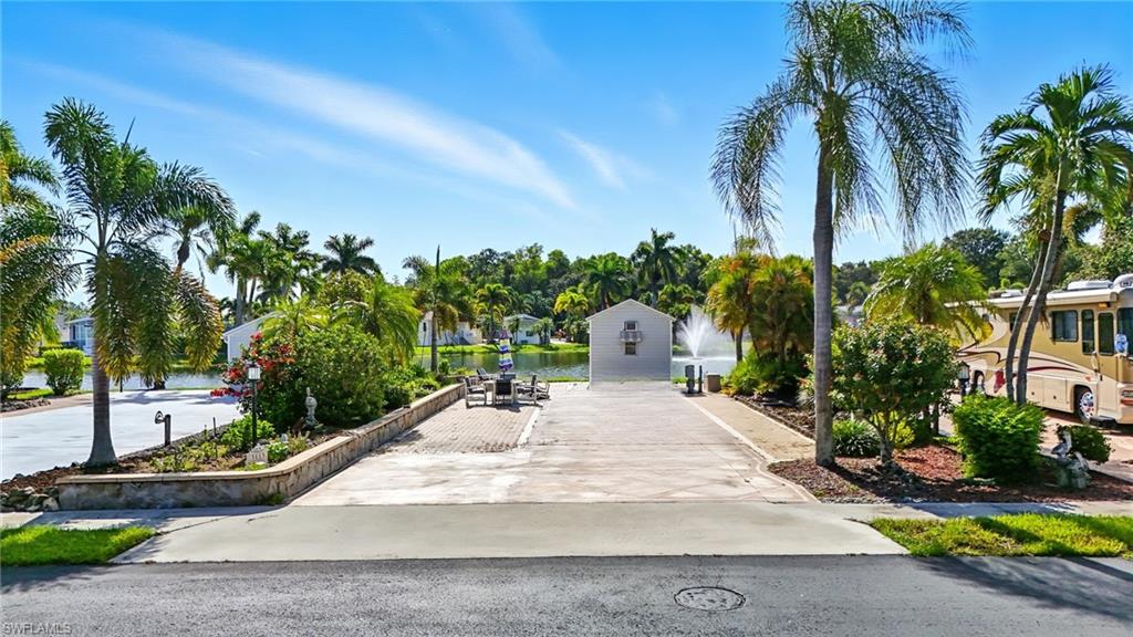 3113 Weathervane Drive Naples, FL 34120 - Photo 6 of 36 a swimming pool with a yard and palm trees