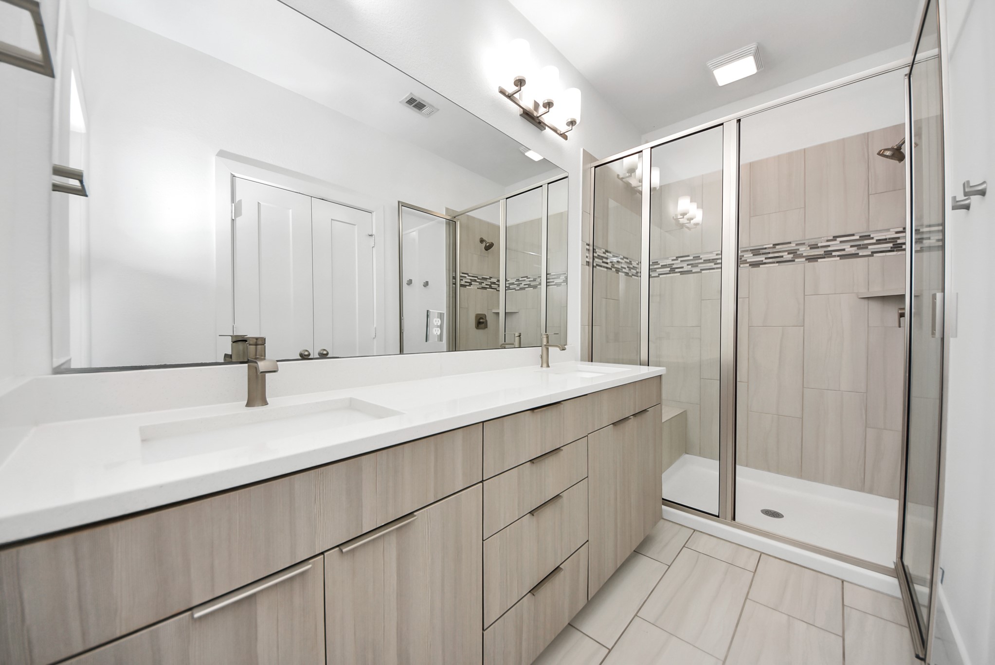 18716 Centro Main Street Conroe, TX 77385 - Photo 37 of 50 Glass-enclosed walk-in shower with modern tile surround, accent detailing, and clean-lined finishes.