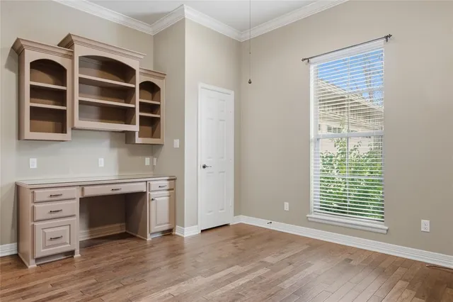 a view of an empty room with a fireplace and a window