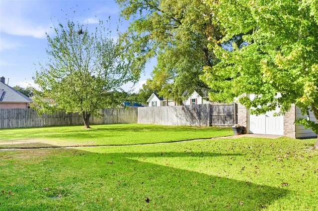 a big yard with lots of green space and trees