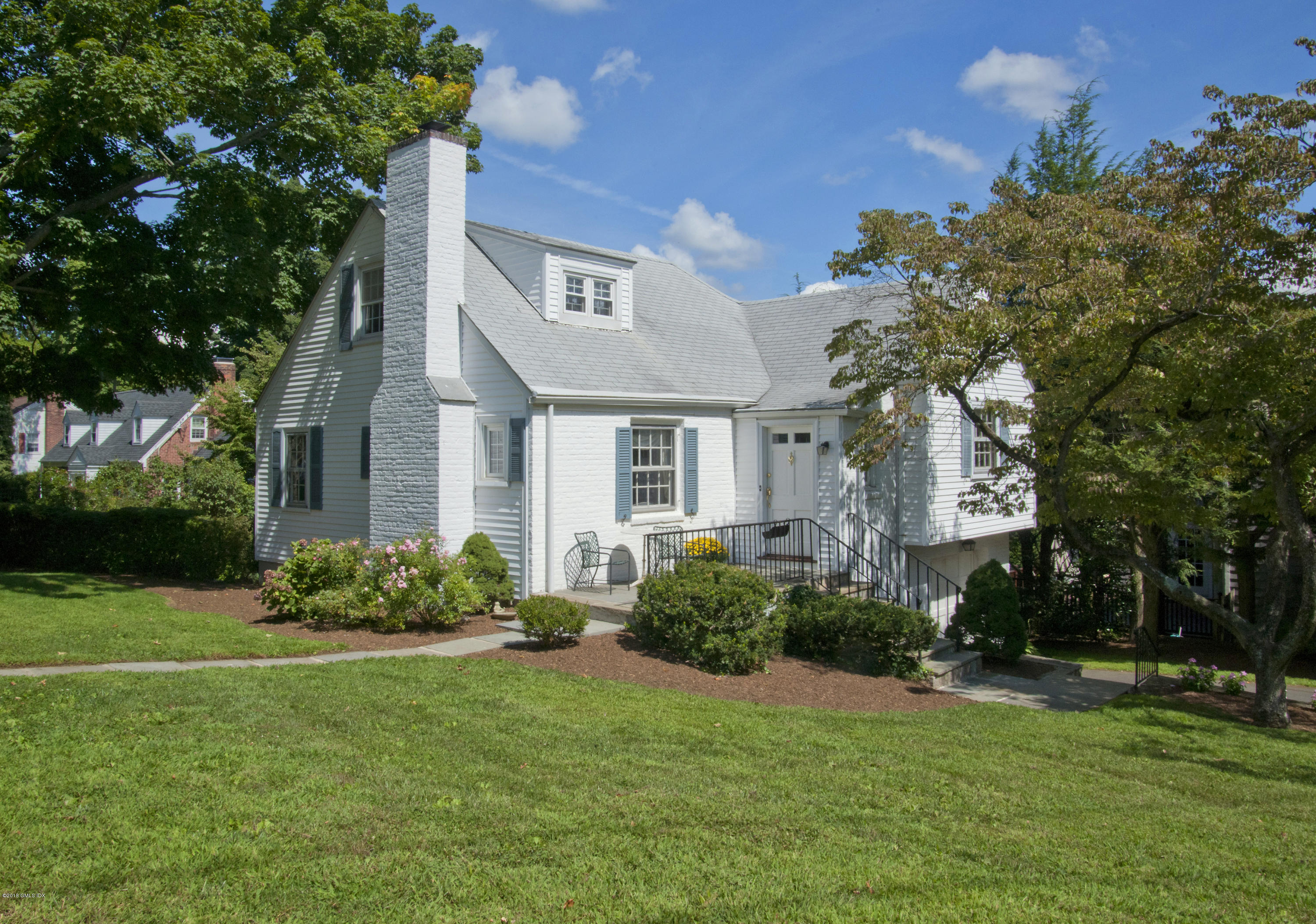 151 Lockwood Road Riverside, CT 06878 - Photo 3 of 20 a front view of a house with a garden