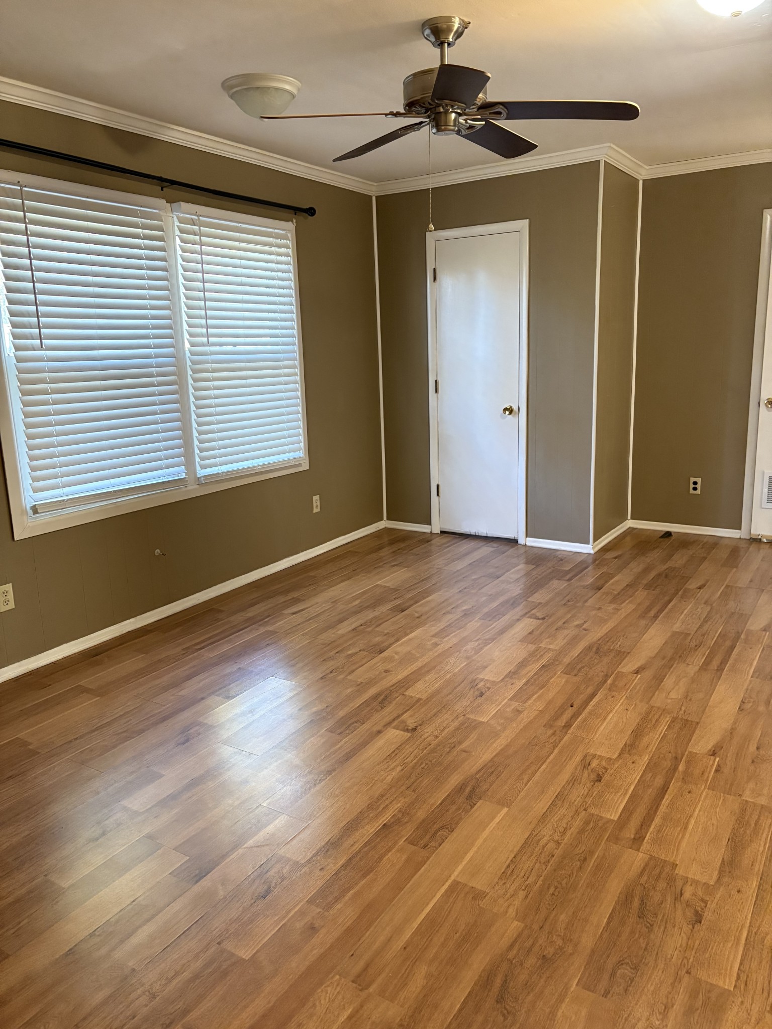 3179 Holly Grove Road Lascassas, TN 37085 - Photo 11 of 15 an empty room with wooden floor cabinet and windows