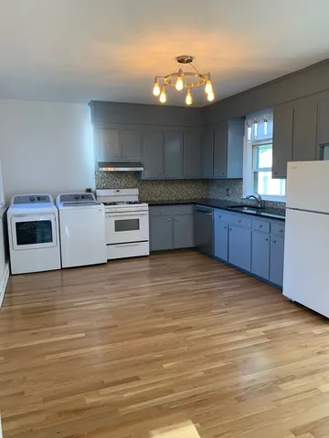 a kitchen with a cabinets and wooden floor
