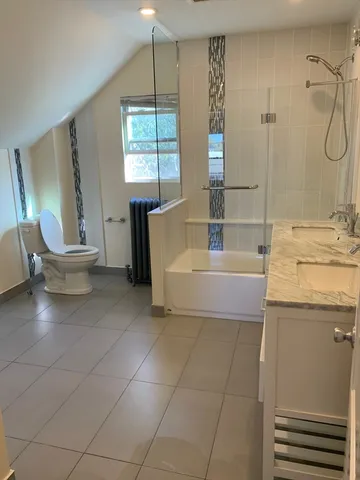 a bathroom with a sink a toilet and tub