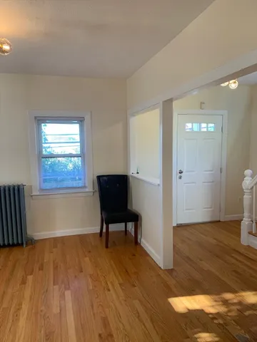 a view of a livingroom with furniture and wooden floor windows