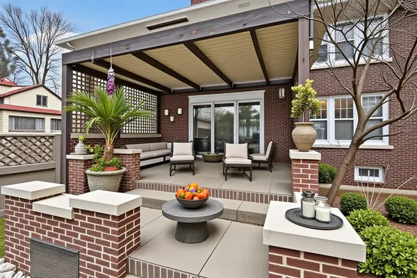 a building outdoor space with patio furniture and potted plants