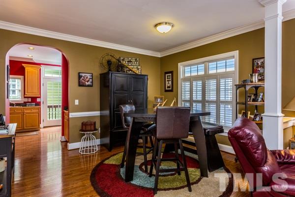 1139 Harp Street Raleigh, NC 27604 - Photo 8 of 25 a dining room with furniture a rug and wooden floor