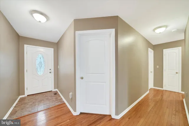 a view of hallway with wooden floor