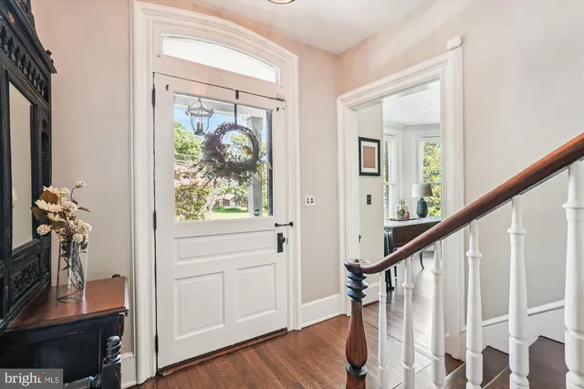 a kitchen with sink refrigerator dining table and chairs