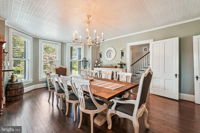 a living room with furniture a rug and a large window