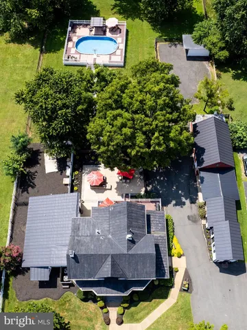 an aerial view of house with yard swimming pool and outdoor seating