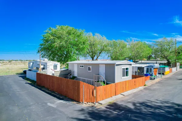 a view of a house with wooden fence