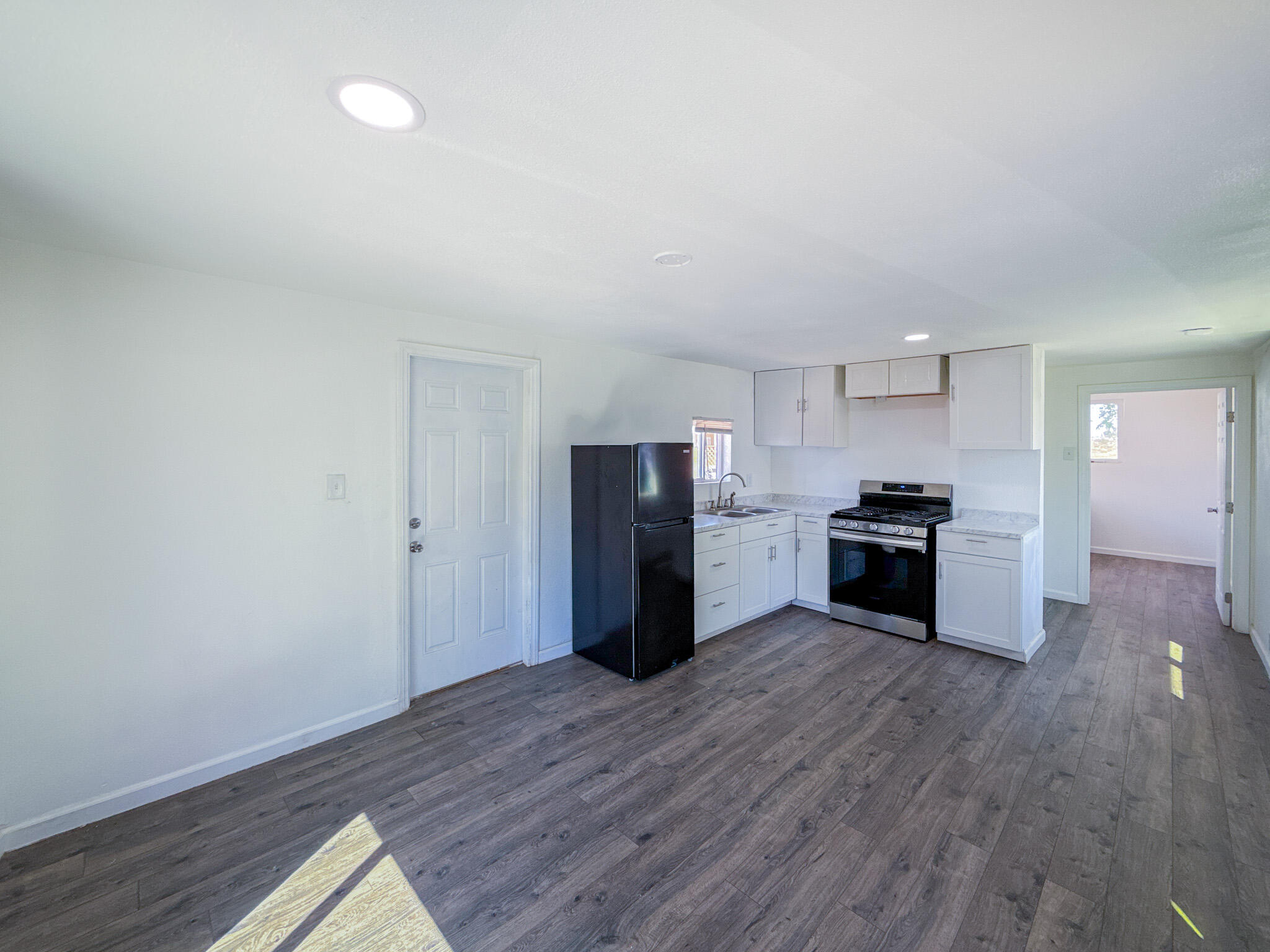 45446 7th Street East Lancaster, CA 93535 - Photo 8 of 16 a kitchen with a refrigerator and a stove top oven