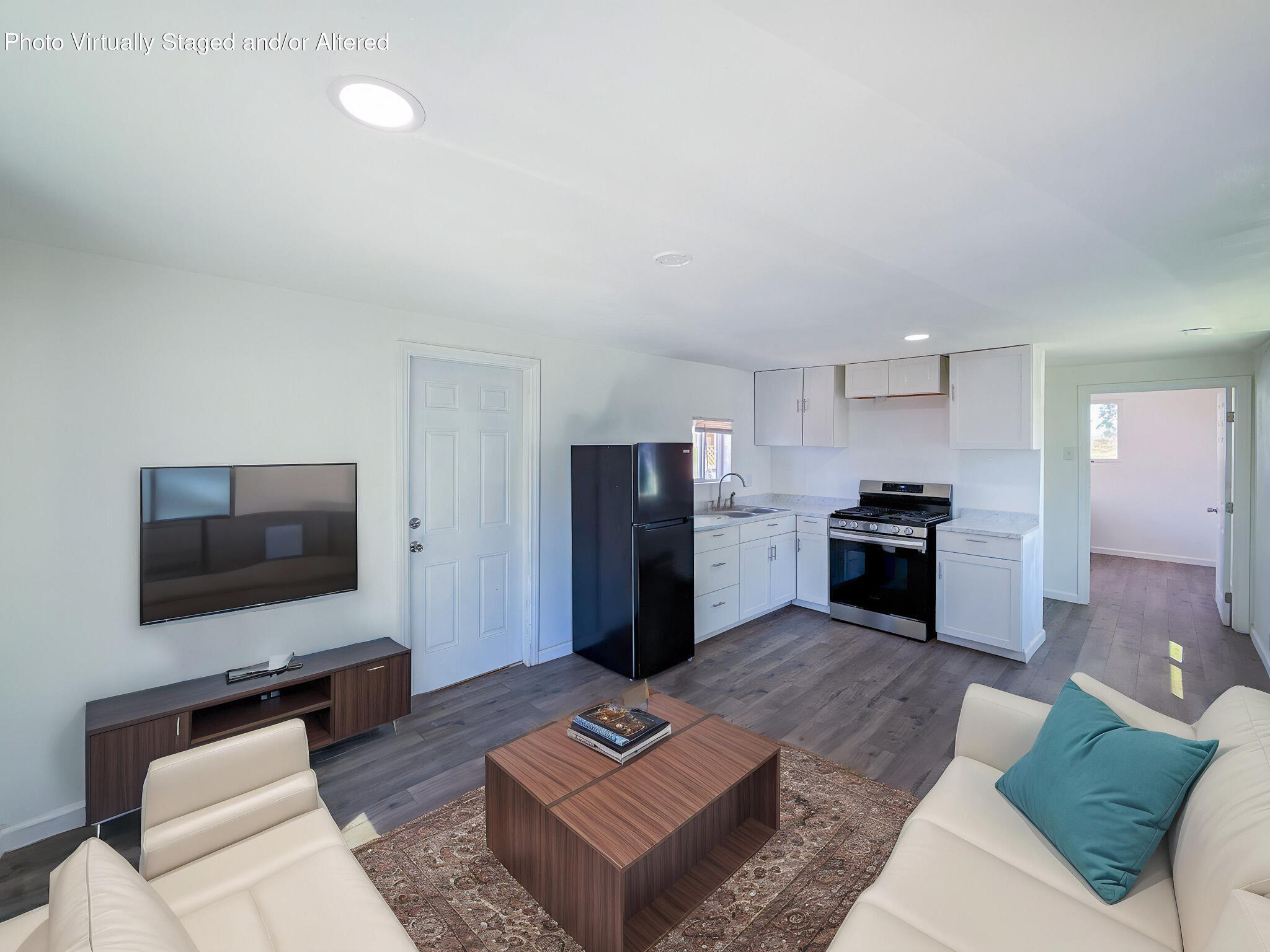 45446 7th Street East Lancaster, CA 93535 - Photo 9 of 16 a living room with furniture and a flat screen tv