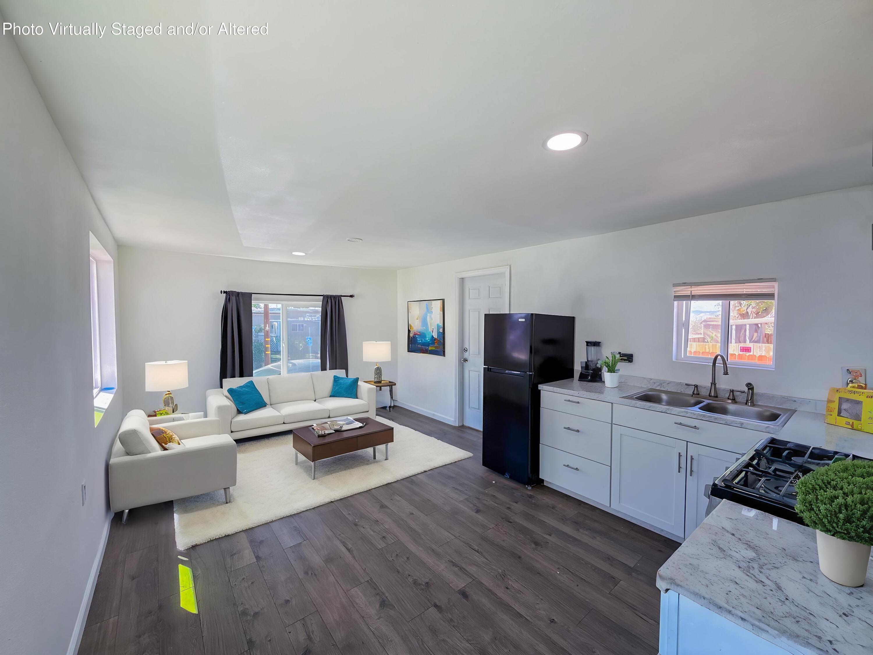 45446 7th Street East Lancaster, CA 93535 - Photo 10 of 16 a living room with furniture and a wooden floor