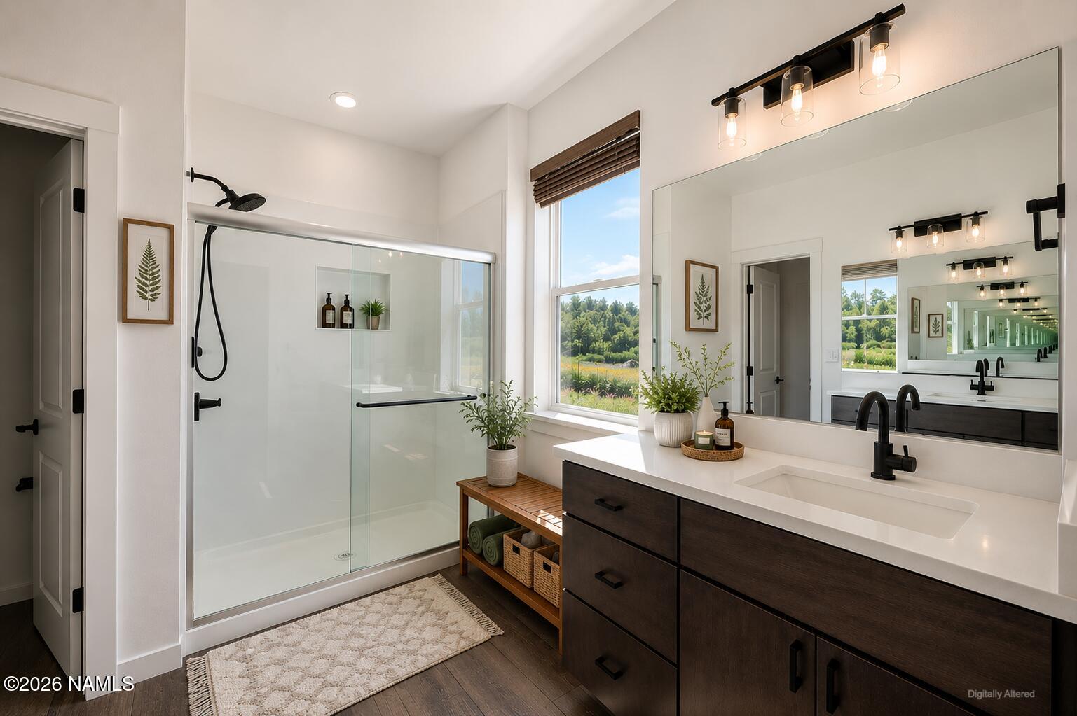 10272 Fw Mclure Road Flagstaff, AZ 86004 - Photo 7 of 38 a bathroom with a double vanity sink a mirror and a shower
