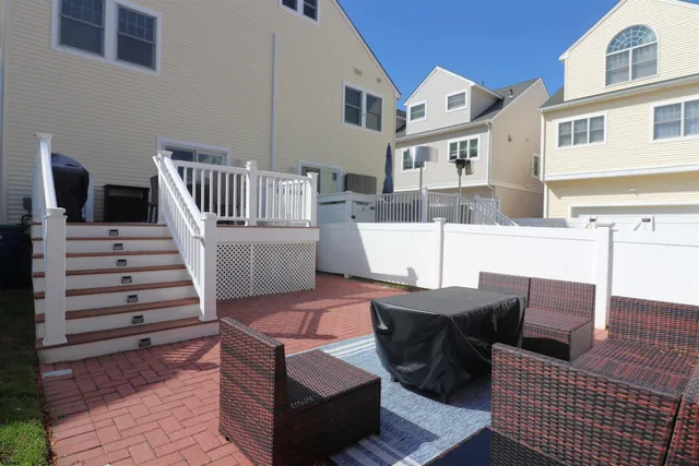 a view of a patio with a table and chairs