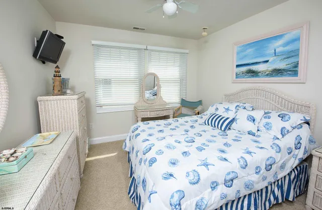 a bedroom with a bed and flat screen tv