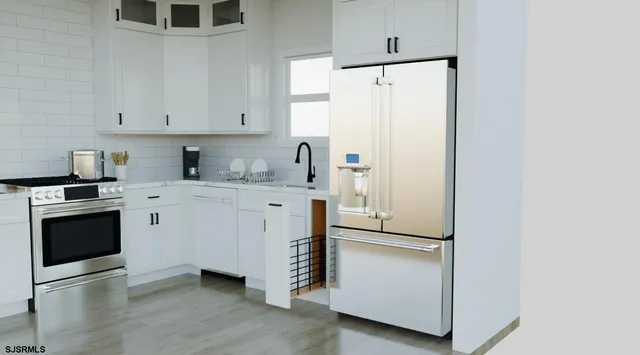 a kitchen with a refrigerator sink and cabinets