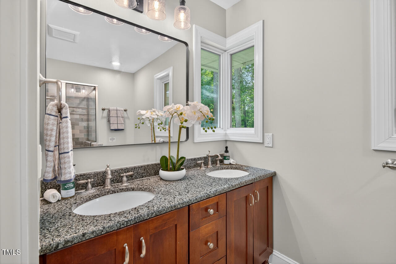 3535 Hope Valley Road Durham, NC 27707 - Photo 13 of 24 a bathroom with a granite countertop sink and a mirror