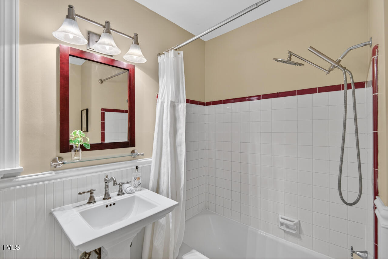 3535 Hope Valley Road Durham, NC 27707 - Photo 17 of 24 a bathroom with a sink vanity mirror and shower