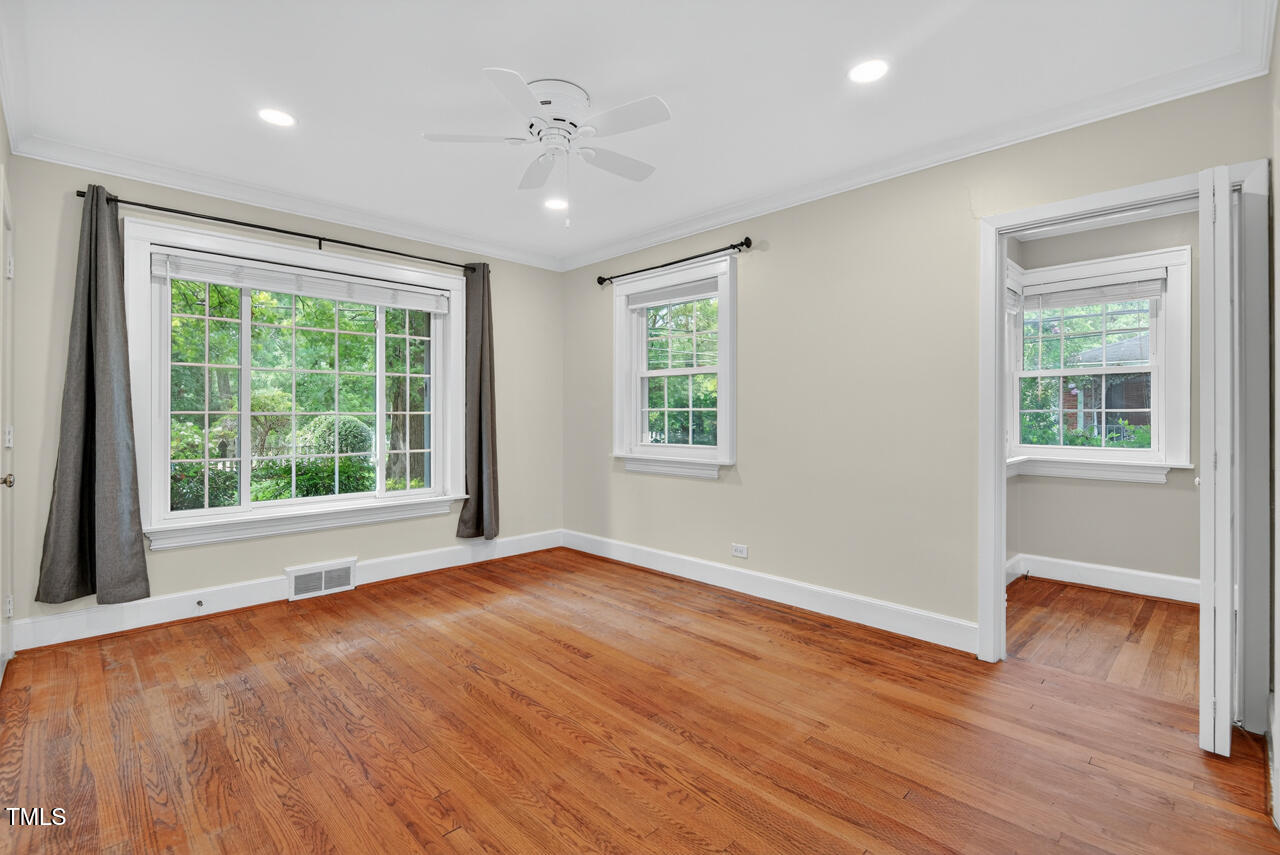 3535 Hope Valley Road Durham, NC 27707 - Photo 18 of 24 a view of an empty room with wooden floor and a window