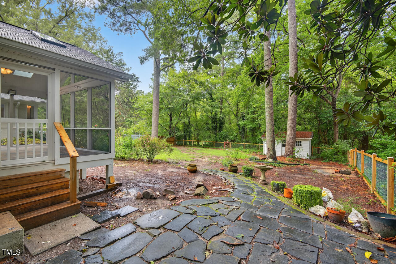 3535 Hope Valley Road Durham, NC 27707 - Photo 20 of 24 a view of backyard with a table and chairs next to a yard