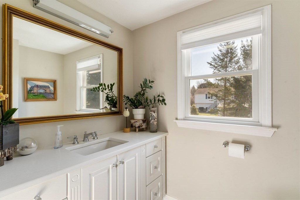 88 Standish Road Needham, MA 02492 - Photo 13 of 26 a bathroom with a granite countertop sink a large mirror and a window