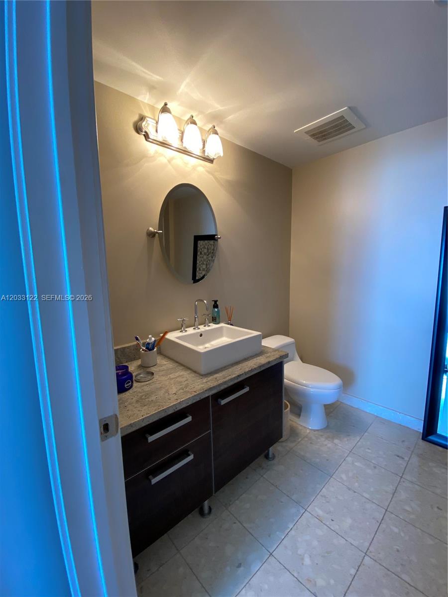 185 Southwest 7th Street, Unit 4206 Miami, FL 33130 - Photo 16 of 26 a bathroom with a sink and a mirror