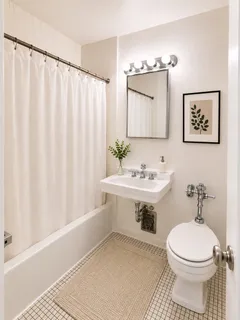 a bathroom with a sink a toilet and shower curtain
