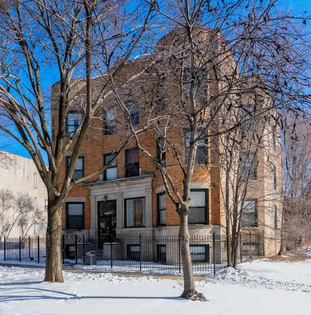 a front view of a building with trees
