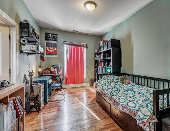 a bedroom with furniture and a book shelf