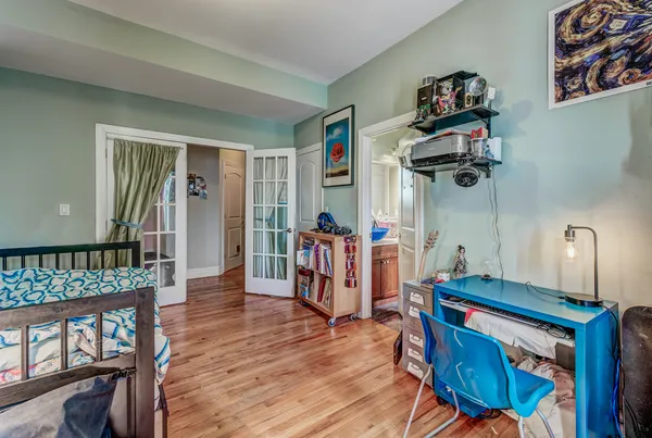 a view of hallway with furniture and wooden floor
